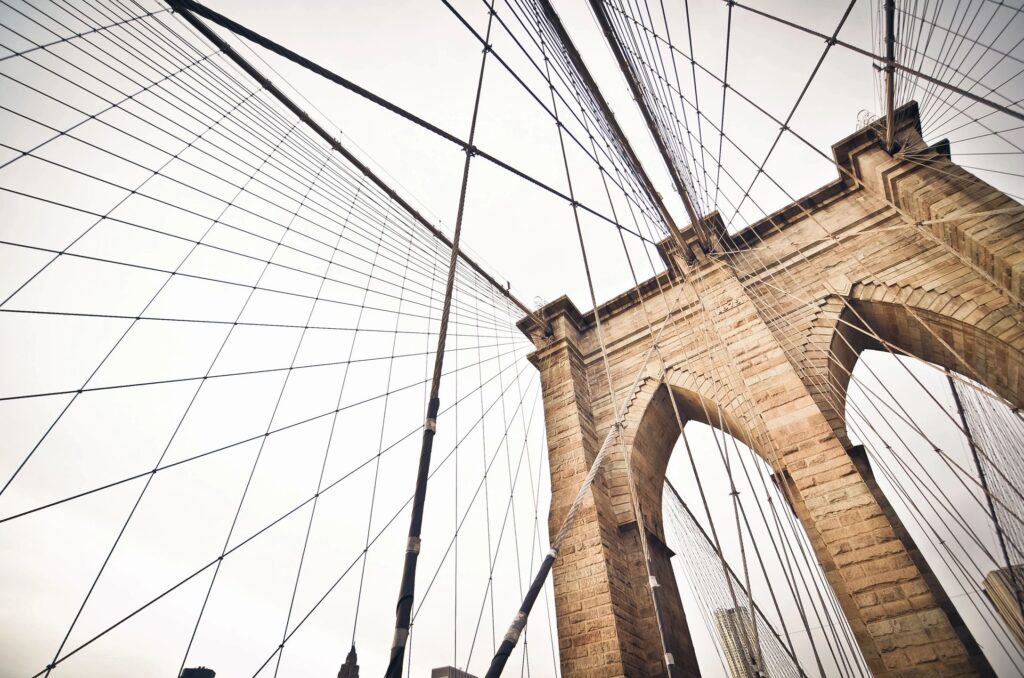 Tall, brick, bridge with suspension wires.